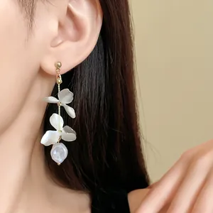 Close-up of elegant French style floral petal tassel earrings with a pearl drop
