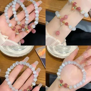 Elegant cat's eye stone beaded bracelet with strawberry charm in a four-panel display