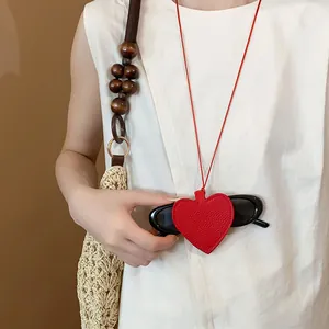 Detail view of stylish red leather heart-shaped sunglasses holder pendant necklace