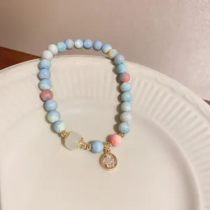 Detailed view of fresh style handmade cat's eye stone beaded bracelet and charm