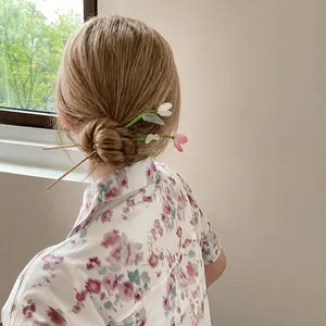 Elegant handmade tulip flower hair stick accessory worn in a bun for Hanfu styling