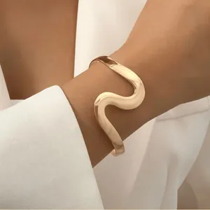 Minimalist gold irregular wave cuff bracelet for women in a highly polished finish