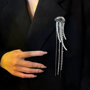 Elegant jellyfish brooch with long pearl and rhinestone tassels pinned to a black blazer