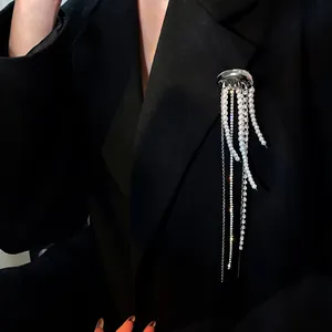 Close-up of elegant jellyfish brooch with long pearl and rhinestone tassels on blazer