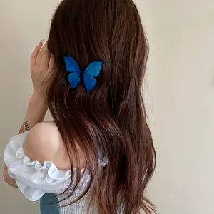 Close-up detail of a realistic blue butterfly hair clip on long brown wavy hair