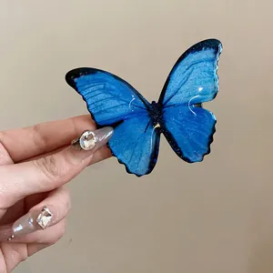 Macro detail of a vibrant blue butterfly hair clip with shimmering glitter finish