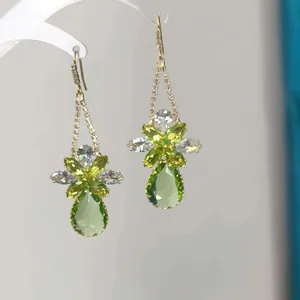 Elegant long geometric earrings with green crystal teardrops and silver needle hooks