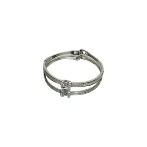 Silver-tone geometric bangle with pavé-set crystals on a white reflective surface