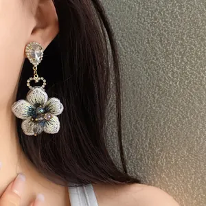 Orecchini a pendente floreali asimmetrici con strass scintillanti e ricami delicati