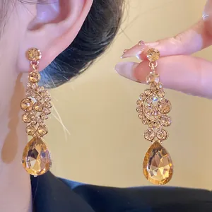 Detailed view of champagne crystal teardrop earrings in vintage court style
