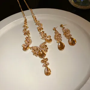 Detailed view of vintage gold-plated jewelry set with champagne teardrop crystals