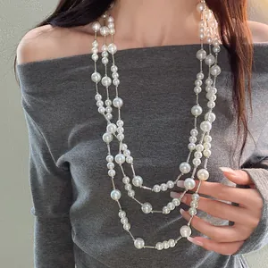 Elegant multi-layer pearl necklace with silver spacers on a model for detail view