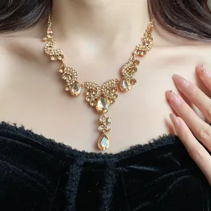 Close-up of vintage palace style necklace with champagne teardrop crystals on model neck