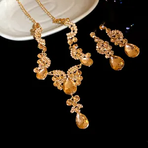 Elegant detail of a vintage champagne gold teardrop rhinestone jewelry set with necklace and earrings