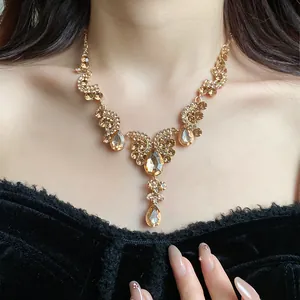 Vintage palace style gold necklace with teardrop crystals and rhinestones close-up