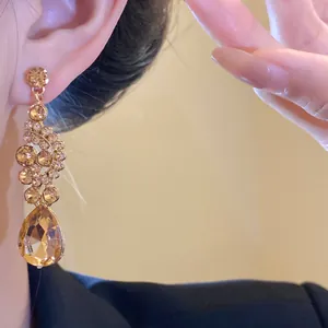 Close-up detail of luxury vintage champagne crystal waterdrop earrings for women
