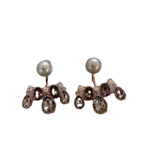 Elegant French retro earrings with grey faux pearls and dark zircons on white background