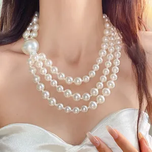 Macro detail of an elegant triple-strand pearl necklace with a vintage French style