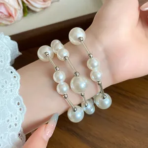 Close-up detail of an elegant French retro faux pearl bracelet worn on a lady's wrist