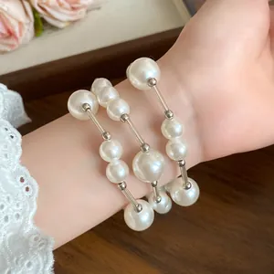 Close-up detail of an elegant French vintage pearl necklace with silver accents on wrist