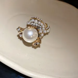 Macro detail of a French vintage gold ring featuring a large central pearl and seed pearls