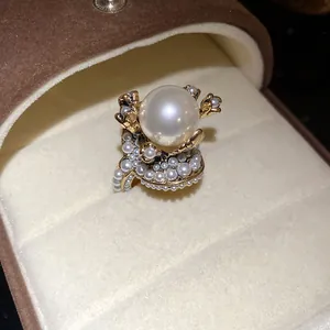 Detailed macro shot of a French vintage gold flower ring featuring a large pearl center