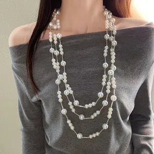 Detailed view of an elegant French vintage multi-layer pearl necklace worn by a model