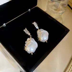 Close-up of vintage-style baroque pearl earrings with sparkling zirconia detailing