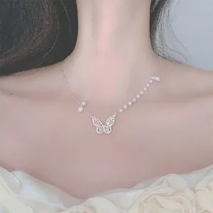 Detail view of an elegant butterfly pendant necklace featuring a pearl spliced chain