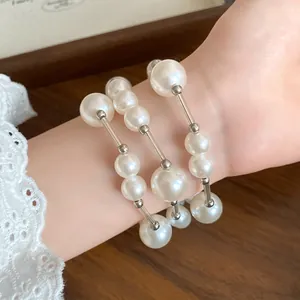Detail view of French vintage pearl necklace worn as a wrap bracelet