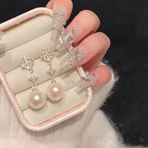 Exquisite close-up view of zircon flower earrings with round lustrous faux pearls