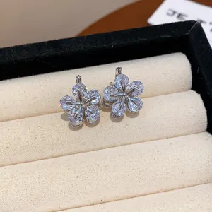 Detailed macro view of exquisite sparkling zircon flower earrings in a velvet jewelry box