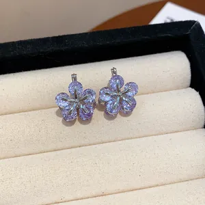 Detailed close-up of sparkling lavender zircon flower earrings presented in a jewelry box