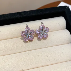 Close-up detail of pink zircon flower-shaped earrings in a jewelry box.