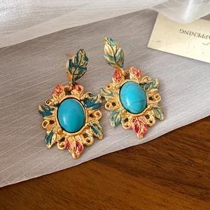 Dettaglio delle orecchini vintage in smalto con pietre turchesi e perni in argento massiccio