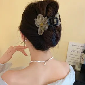 Gros plan d'une pince à cheveux fleurie en tulle pour un chignon élégant et romantique