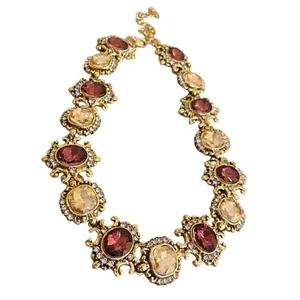 Vintage ornate gold-tone palace style necklace set with red and champagne crystals