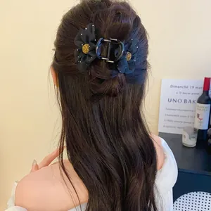 Élégante pince à cheveux fleur en résille noire de style français vue de derrière