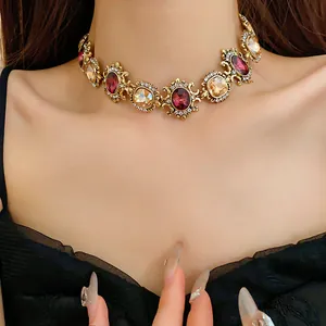 Detailed macro view of a vintage palace-style choker necklace with ornate gemstones