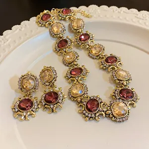 Close-up detail of vintage baroque style necklace and earring set with crystals.