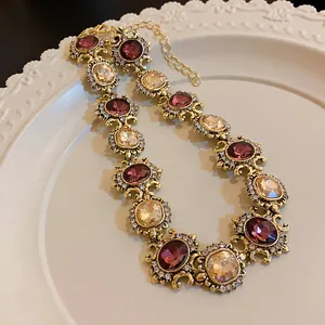 Detailed macro shot of vintage palace style necklace with purple and champagne crystals
