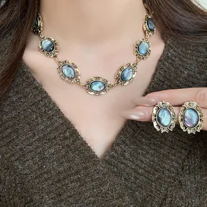 Close-up of model wearing a vintage oval iridescent resin necklace and earring set