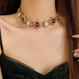 Detailed macro shot of vintage palace-style choker with red and champagne gemstones.