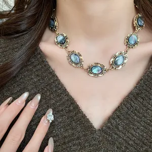 Detail view of vintage oval resin choker necklace with ornate gold-toned metal frames.