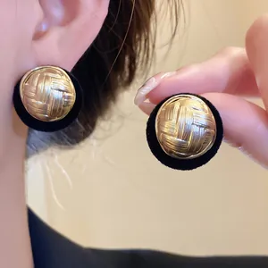 Vintage gold textured round stud earrings with elegant black flocked border detailing