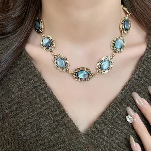 Close-up of a vintage oval resin necklace in gold tone worn by a model.