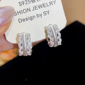 Macro view of detailed 18K gold plated hoop earrings with zircon stones in palace style