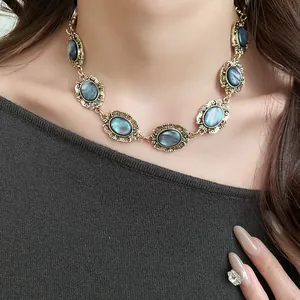 Detailed close-up of a vintage gold-tone choker necklace with iridescent oval resin links