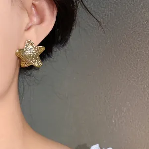 Elegant gold-plated star stud earrings featuring a unique pleated ripple texture for women