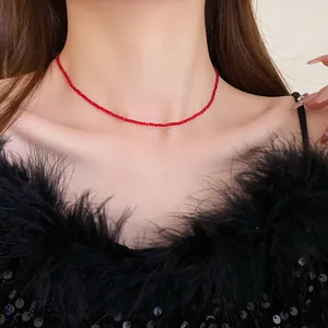 Close-up of delicate red beaded choker necklace worn on neck for a minimalist look